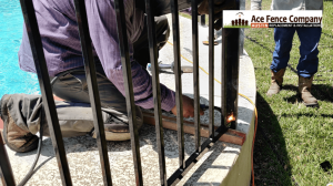 fence contractor installing wrought iron fence